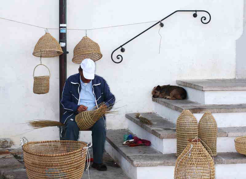 fisherman making handmade woven fish traps